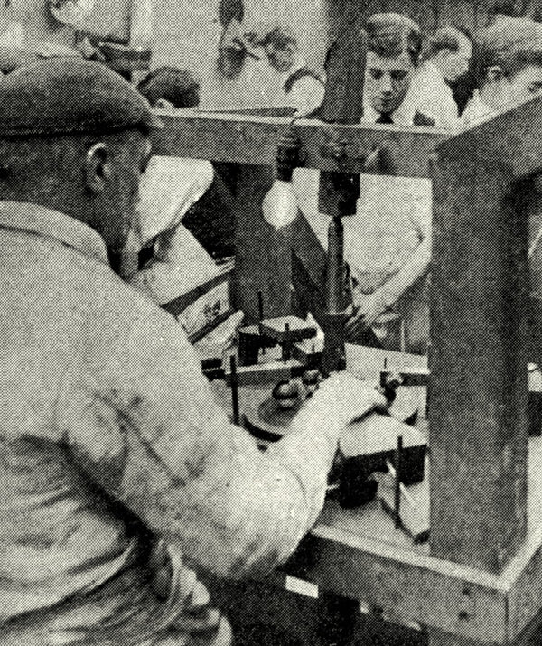 Black and white photograph of men at a factory polishing diamonds