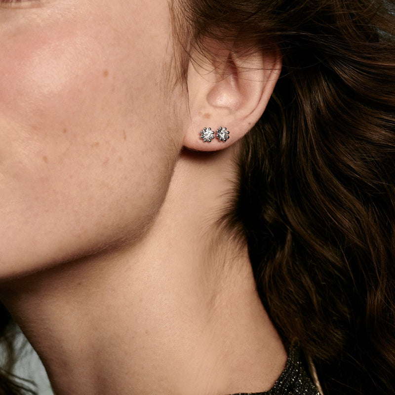 Woman wearing Oscar Massin fine jewelry small stud earrings in recycled white gold with sustainable lab grown diamonds
