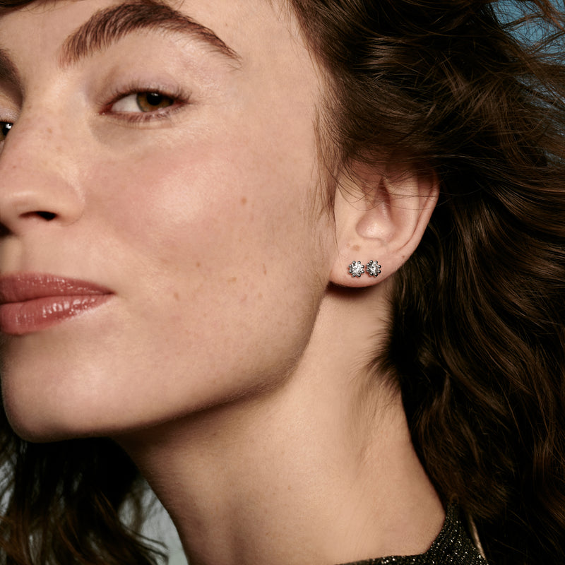 Woman wearing Oscar Massin fine jewelry small stud earrings in recycled white gold with sustainable lab grown diamonds