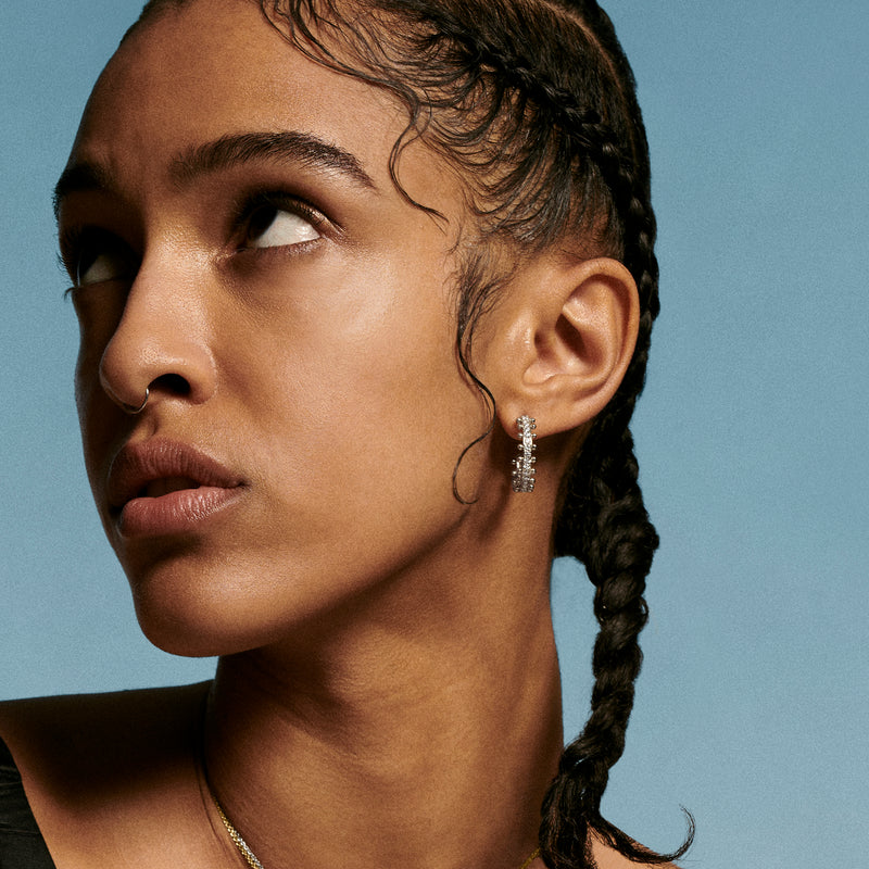 Woman wearing large beaded hoops earrings in recycled white gold and using sustainable lab grown diamonds by Oscar Massin