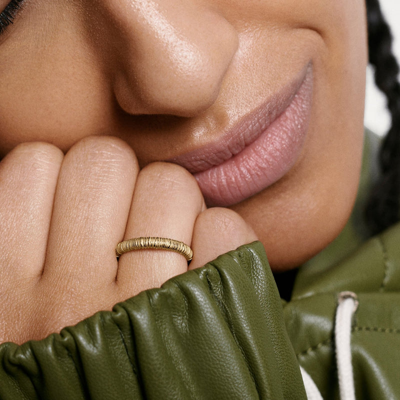 Woman wearing Oscar Massin filigree ring in recycled yellow gold