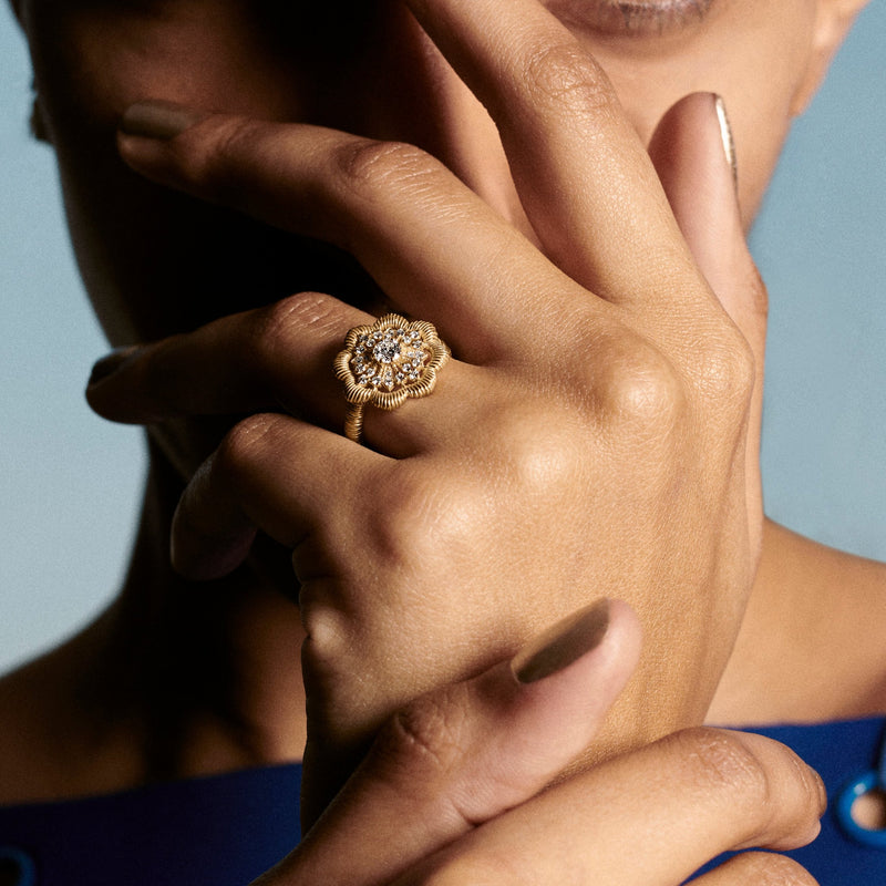 Woman wearing Oscar Massin large lace flower ring in recycled yellow gold with sustainable lab grown diamonds
